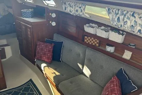 Slide: The Image of Interior of 1987 Catalina 30 Mk II sailboat with cozy seating and nautical decor. - 17