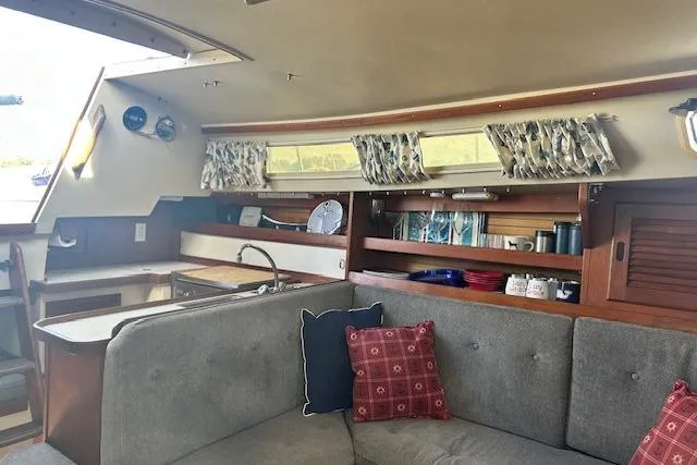 Slide: The Image of Interior of 1987 Catalina 30 Mk II sailboat with cozy seating and nautical decor. - 19