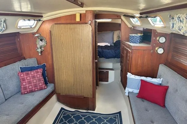 Slide: The Image of Interior of 1987 Catalina 30 Mk II sailboat with cozy seating and nautical decor. - 20