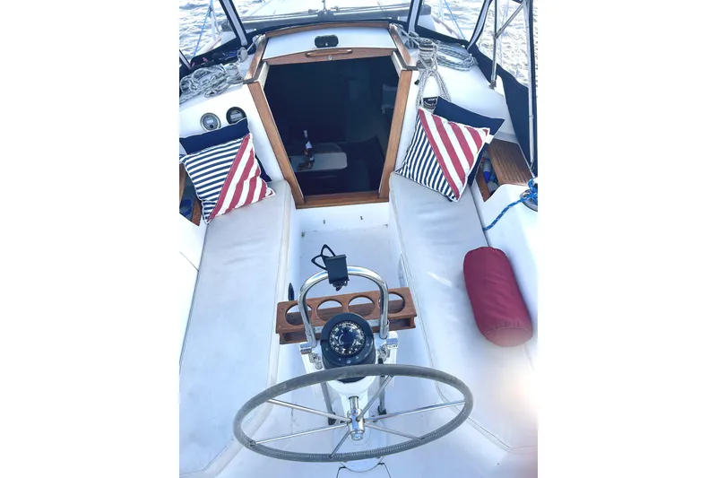 Slide: The Image of Cockpit of 1987 Catalina 30 Mk II sailboat with striped cushions and steering wheel. - 5