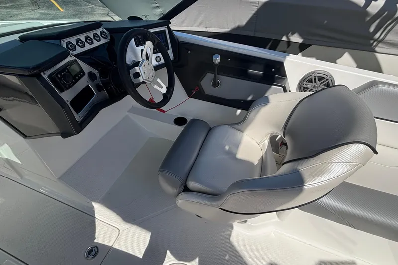 Slide: The Image of 2015 MasterCraft NXT20 boat interior with steering wheel and captain's seat. - 13