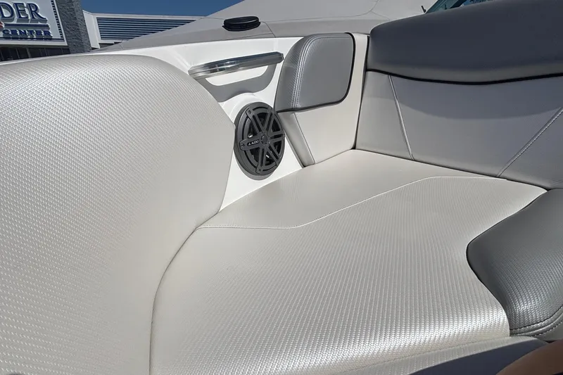 Slide: The Image of 2015 MasterCraft NXT20 boat interior with white and gray seating and speaker. - 17