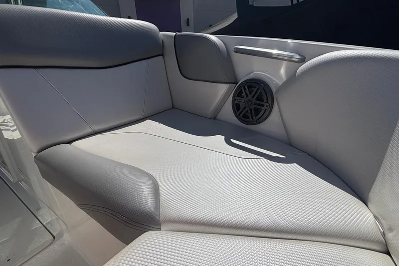 Slide: The Image of 2015 MasterCraft NXT20 boat interior with cushioned seating and speaker. - 18