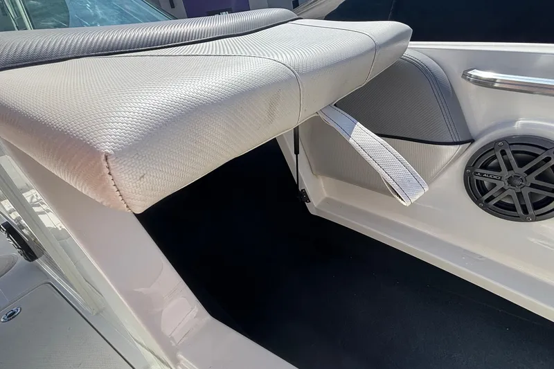 Slide: The Image of 2015 MasterCraft NXT20 boat interior with cushioned seating and JL Audio speaker. - 21