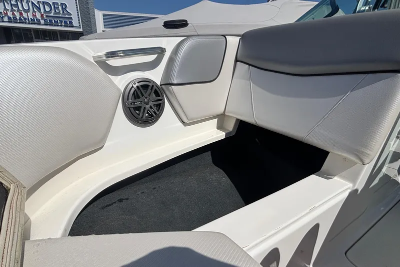 Slide: The Image of 2015 MasterCraft NXT20 boat interior with speaker and cushioned seating. - 22