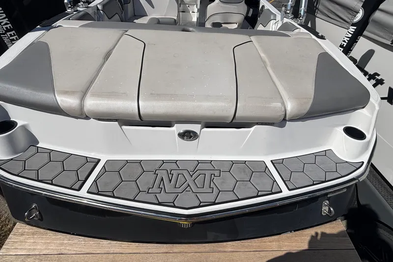 Slide: The Image of 2015 MasterCraft NXT20 boat with cushioned seating and hexagonal deck design. - 3