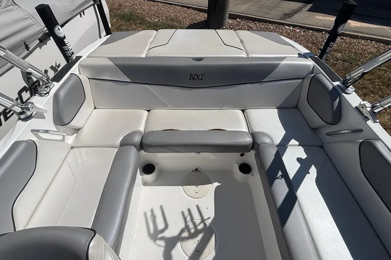 Slide: The Image of 2015 MasterCraft NXT20 boat interior with gray and white seating arrangement. - 5
