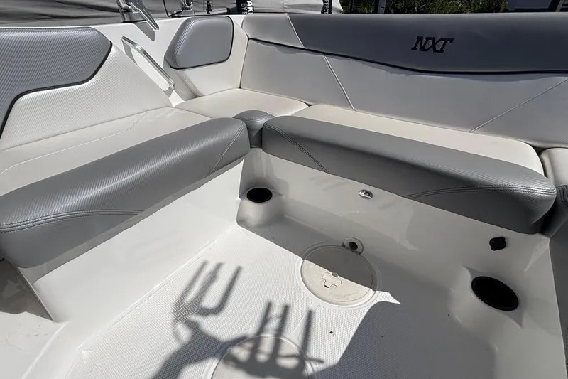 Slide: The Image of 2015 MasterCraft NXT20 boat interior with gray seating and cup holders. - 6