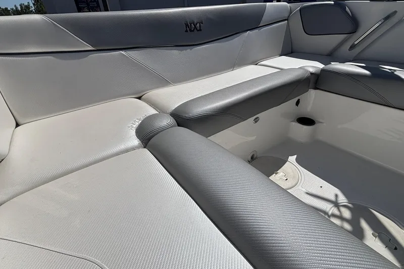 Slide: The Image of 2015 MasterCraft NXT20 boat interior with gray and white seating. - 7