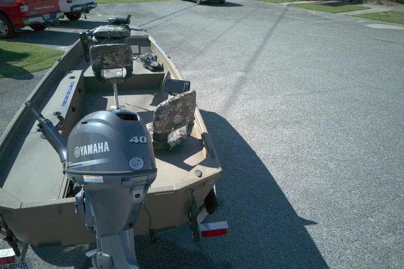 Slide: The Image of Boat with Yamaha 40 engine, camo seats, parked on pavement. G3 15DK, 2025 model. - 10