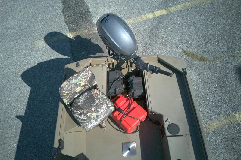Slide: The Image of Top view of a 2025 G3 15DK boat with camo seat and outboard motor. - 5
