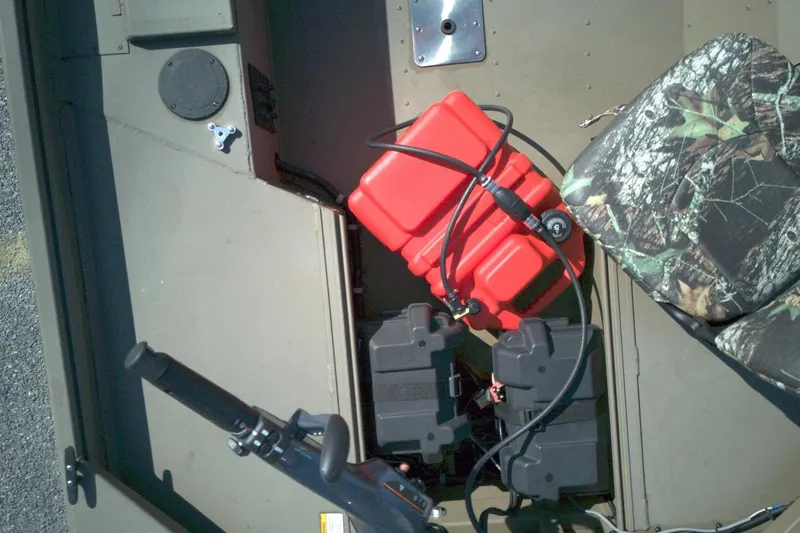 Slide: The Image of Interior of a G3 15DK boat, featuring camo seat, red fuel tank, and battery setup. - 8