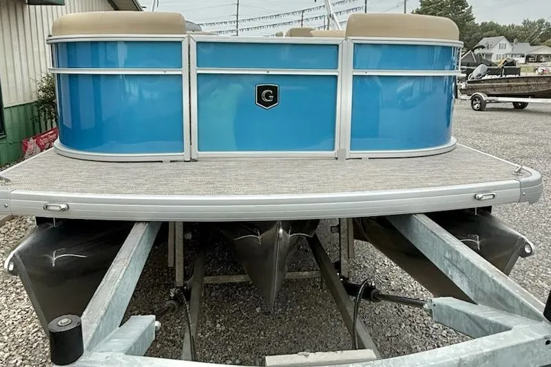 Slide: The Image of 2026 Godfrey Xperience EX2286SBX pontoon boat with blue exterior on a trailer. - 1