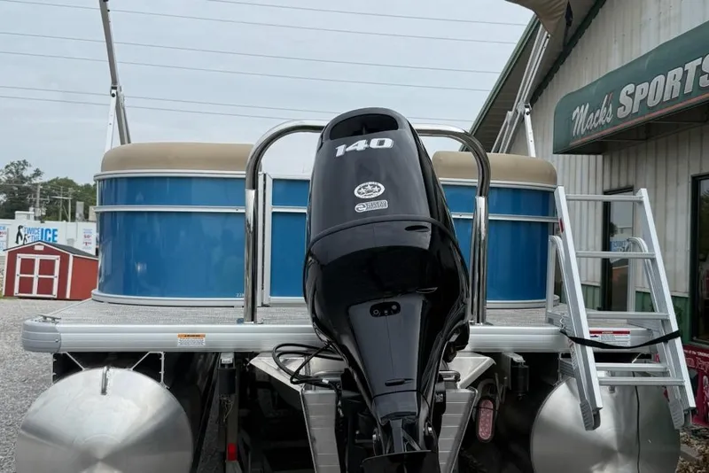 Slide: The Image of 2026 Godfrey Xperience EX2286SBX pontoon boat with 140 HP engine at dealership. - 2