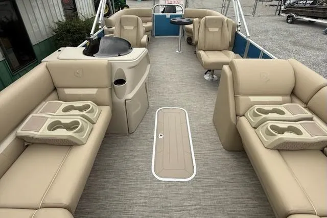 Slide: The Image of Luxurious 2026 Godfrey Xperience EX2286SBX pontoon boat interior with beige seating and cup holders. - 6