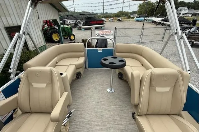 Slide: The Image of 2026 Godfrey Xperience EX2286SBX pontoon boat with beige seating and table, showroom display. - 7