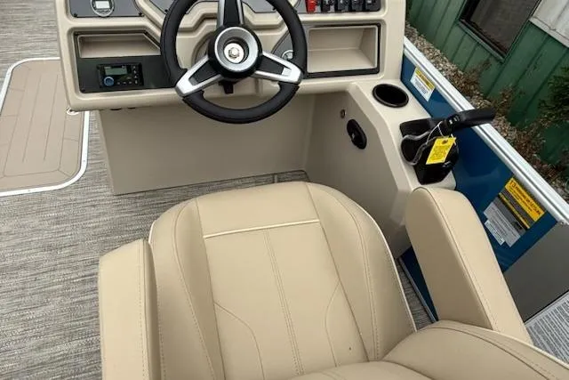 Slide: The Image of 2026 Godfrey Xperience EX2286SBX boat interior with steering wheel and beige seating. - 8