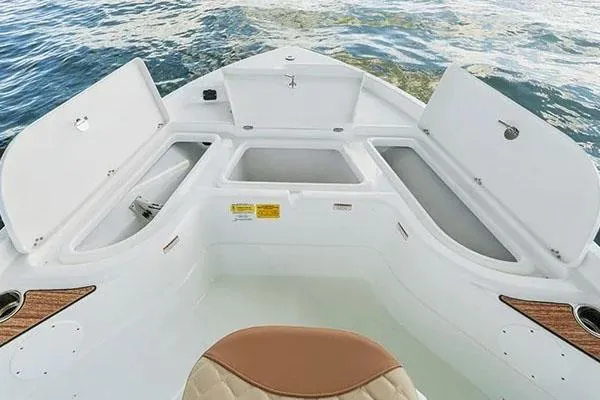 Slide: The Image of Manufacturer Provided Image: 2024 NauticStar 194 Bay boat with open storage compartments on the water. - 4