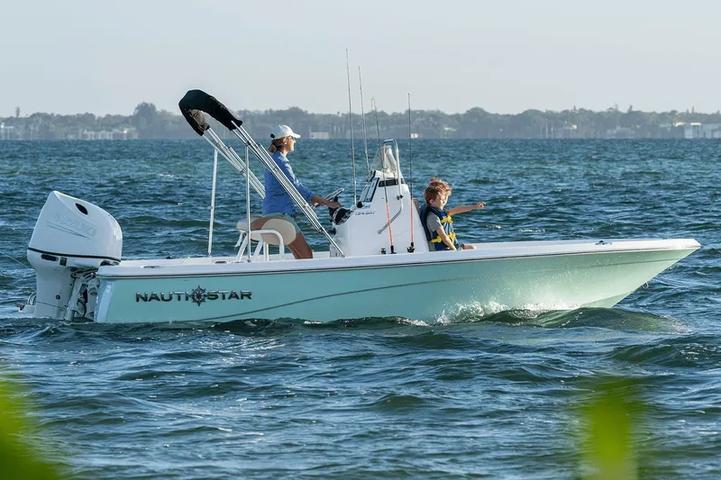 Slide: The Image of Manufacturer Provided Image: 2024 NauticStar 194 Bay boat cruising on open water. - 1