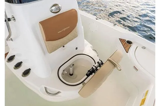 Slide: The Image of Manufacturer Provided Image: 2024 NauticStar 194 Bay boat interior with tan seating and storage compartment. - 5