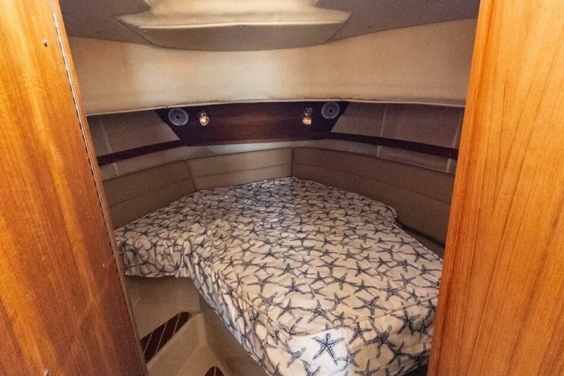 Slide: The Image of 2019 Ranger Tugs R-31-S cabin interior with starfish-patterned bedding. - 11
