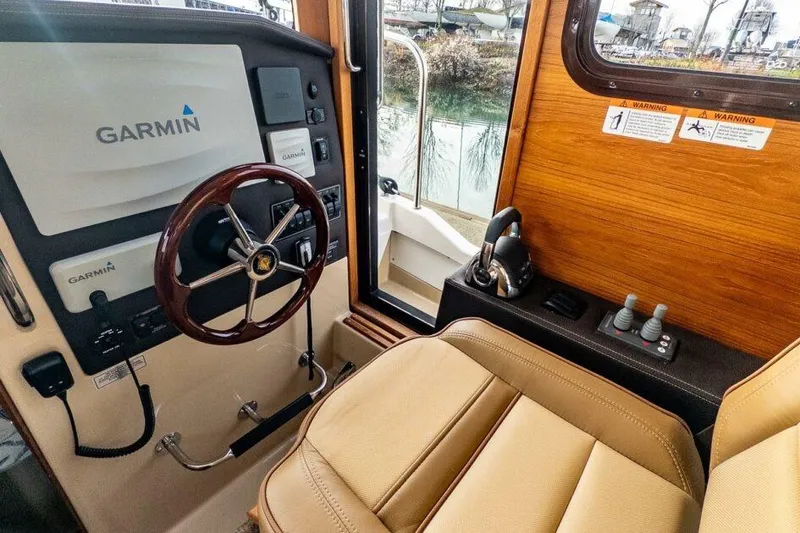 Slide: The Image of 2019 Ranger Tugs R-31-S helm with Garmin navigation system and leather seating. - 14