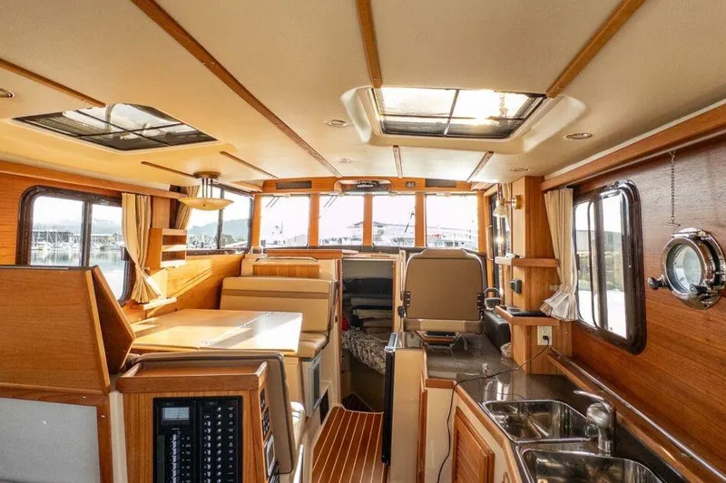 Slide: The Image of Interior of 2019 Ranger Tugs R-31-S boat with wood finish and modern amenities. - 17