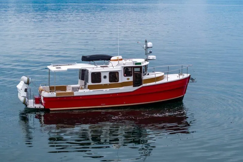 Slide: The Image of 2019 Ranger Tugs R-31-S boat on calm water, featuring a vibrant red hull. - 4