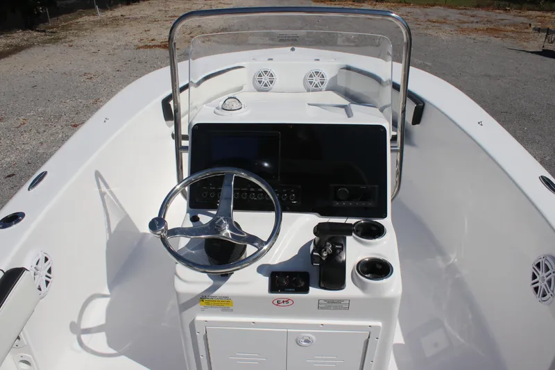 Slide: The Image of 2026 Tidewater 180 CC Adventure boat console with steering wheel and controls. - 11