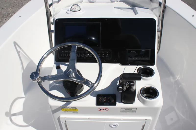Slide: The Image of 2026 Tidewater 180 CC Adventure boat console with steering wheel and controls. - 12