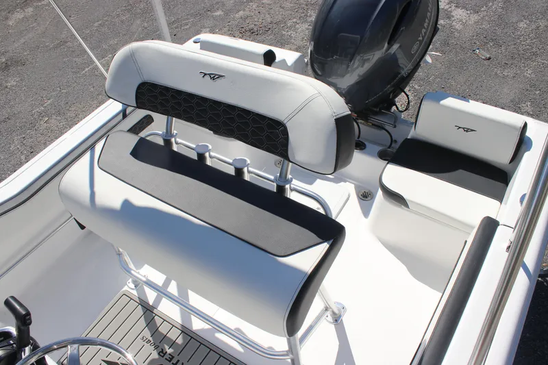 Slide: The Image of 2026 Tidewater 180 CC Adventure boat interior with seating and motor. - 14
