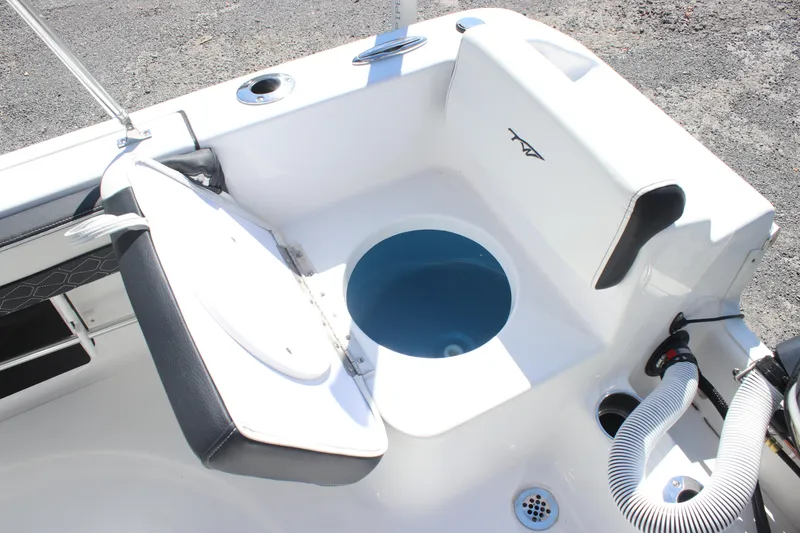 Slide: The Image of 2026 Tidewater 180 CC Adventure boat with open storage compartment and seating. - 16