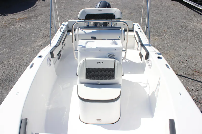 Slide: The Image of 2026 Tidewater 180 CC Adventure boat interior with seating and console, on a gravel surface. - 7