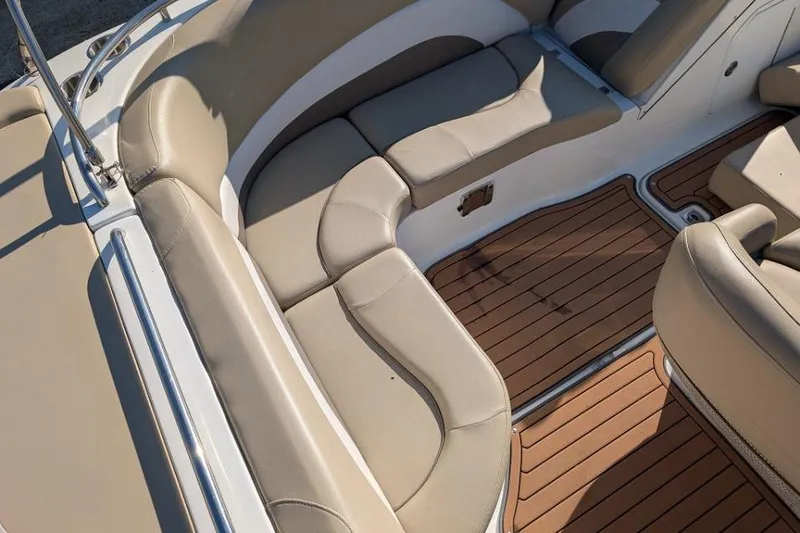 Slide: The Image of 2017 Hurricane SunDeck Sport 201 IO boat interior with beige seating and wood-style flooring. - 4