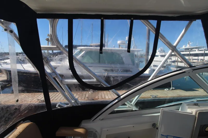 Slide: The Image of Interior view of a 2001 Mako 293 Walk Around boat at a marina. - 11