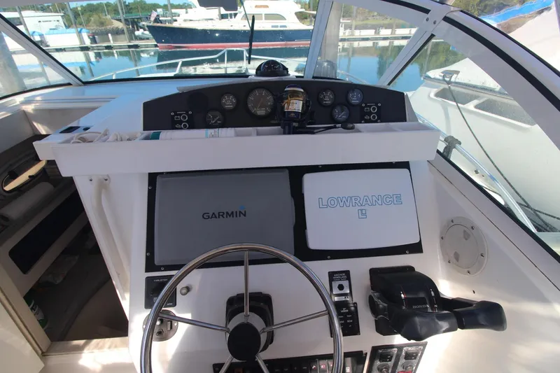 Slide: The Image of Cockpit of 2001 Mako 293 Walk Around with Garmin and Lowrance navigation systems. - 14