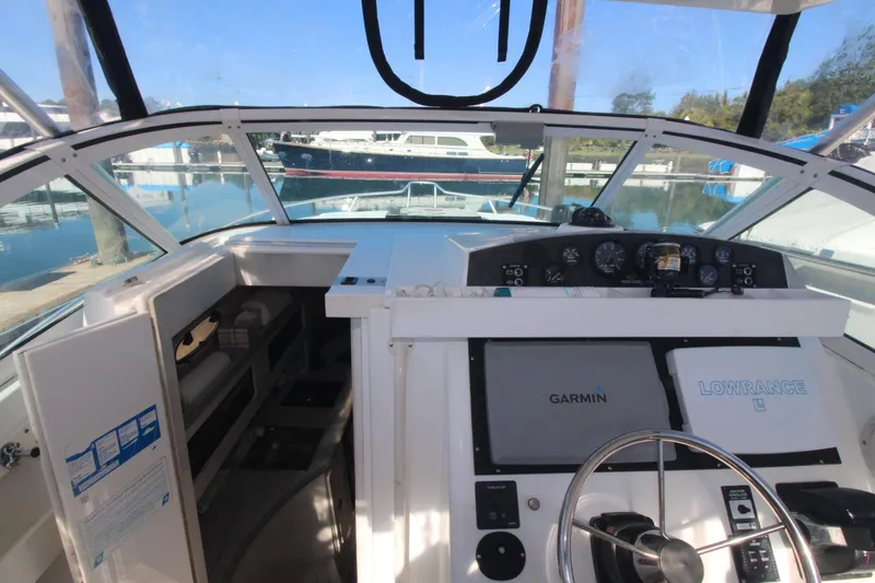 Slide: The Image of 2001 Mako 293 Walk Around boat cockpit with Garmin and Lowrance navigation systems. - 16