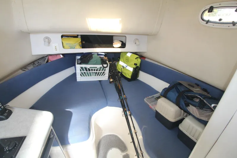Slide: The Image of Interior of 2001 Mako 293 Walk Around boat with fishing gear and storage. - 19
