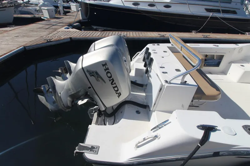 Slide: The Image of 2001 Mako 293 Walk Around boat with Honda outboard motor at dock. - 4