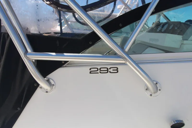Slide: The Image of 2001 Mako 293 Walk Around boat with stainless steel railings and model number displayed. - 6