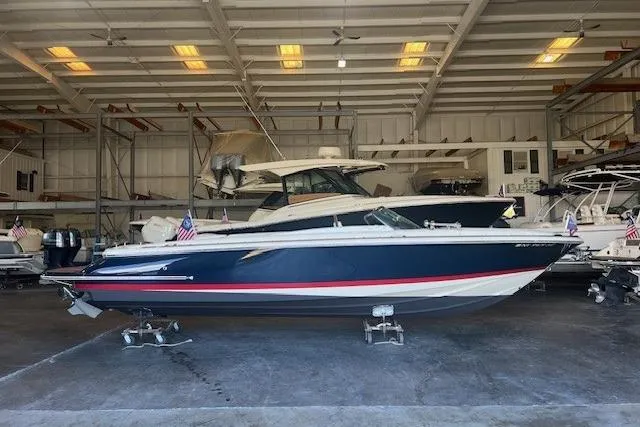 The Image of 2024 Chris-Craft Launch 27 boat in a storage facility, side view. - 0