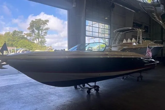 Slide: The Image of 2024 Chris-Craft Launch 27 boat in a showroom, side view. - 2