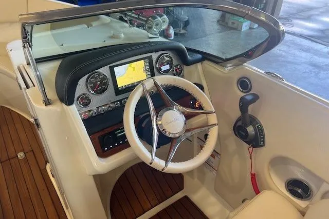 Slide: The Image of 2024 Chris-Craft Launch 27 dashboard with steering wheel, navigation display, and control panel. - 21
