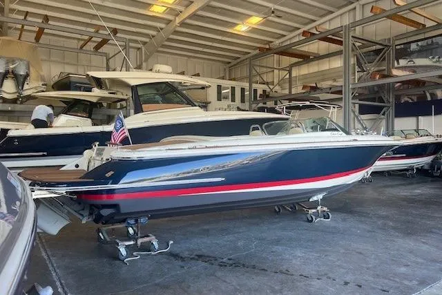 Slide: The Image of 2024 Chris-Craft Launch 27 boat in a storage facility, featuring sleek design and American flag. - 3