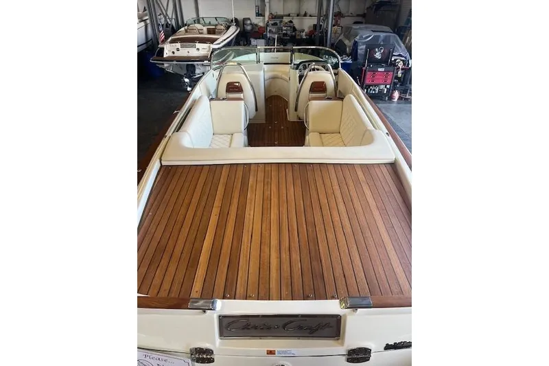 Slide: The Image of 2024 Chris-Craft Launch 27 boat with elegant wooden deck and luxurious seating. - 9