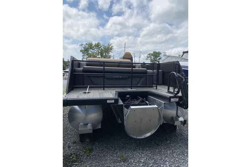 Slide: The Image of 2025 Viaggio Lago Z-S pontoon boat on gravel, under cloudy sky. - 14