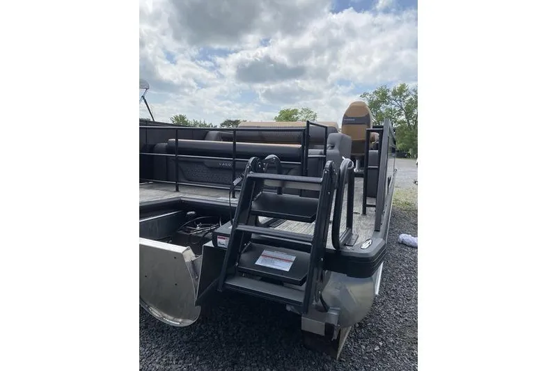 Slide: The Image of 2025 Viaggio Lago Z-S pontoon boat with rear entry ladder and seating, under cloudy sky. - 15