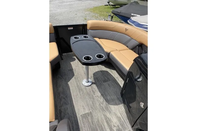 Slide: The Image of 2025 Viaggio Lago Z-S boat interior with tan seating and a black table. - 19