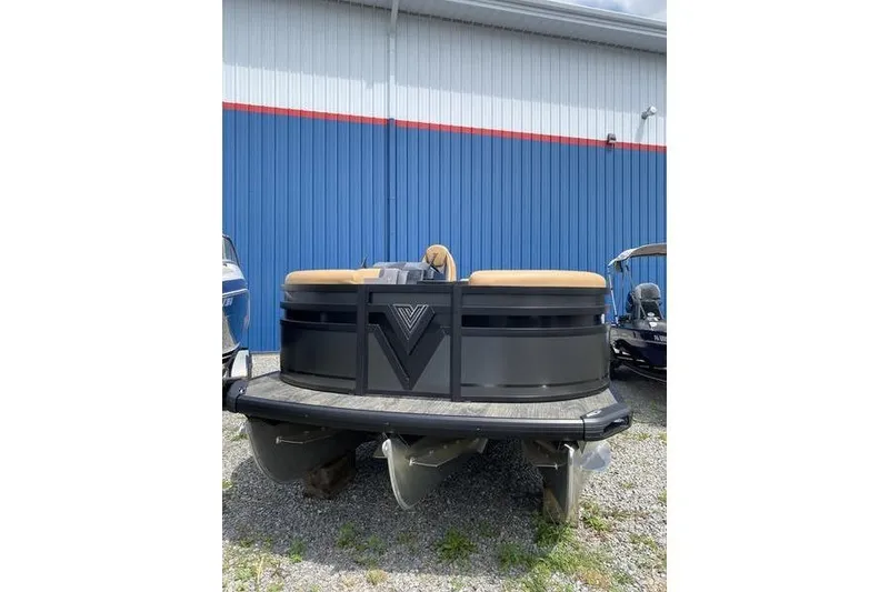 Slide: The Image of 2025 Viaggio Lago Z-S pontoon boat, front view, parked outdoors near blue building. - 2