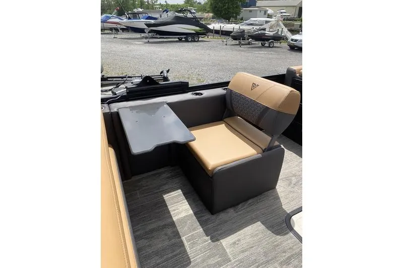Slide: The Image of 2025 Viaggio Lago Z-S boat interior with tan and gray seating, foldable table, and cup holder. - 20